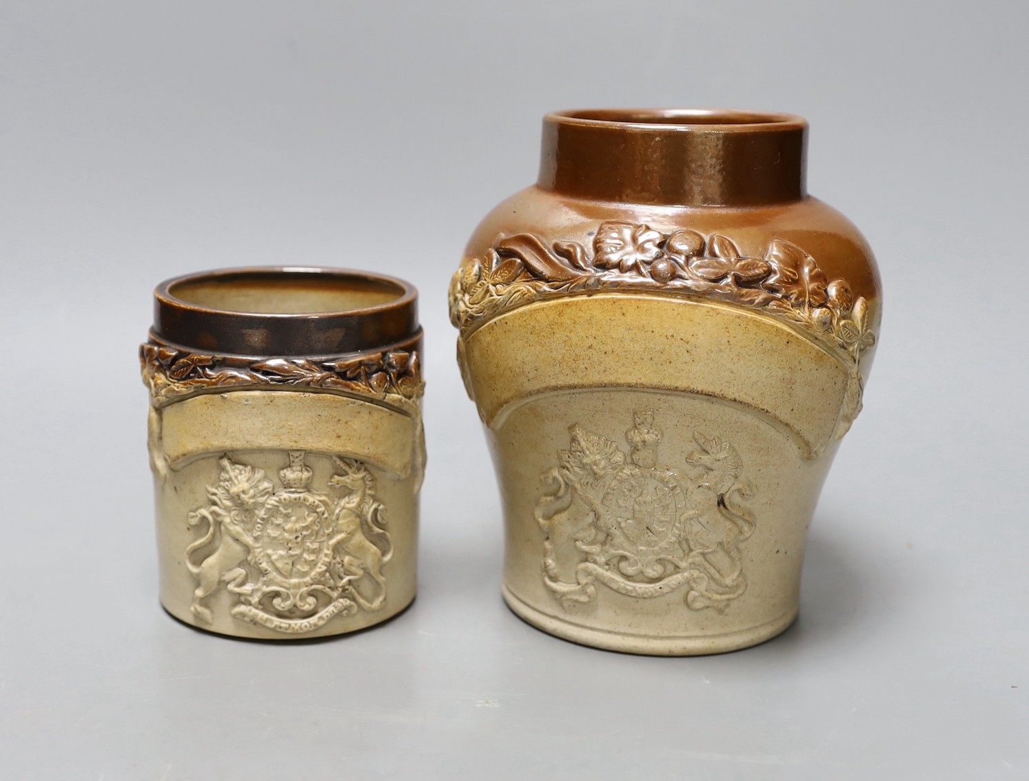 Two 19th century salt glazed stoneware storage jars, with Royal coat of arms sprigging, Tallest 18cm high